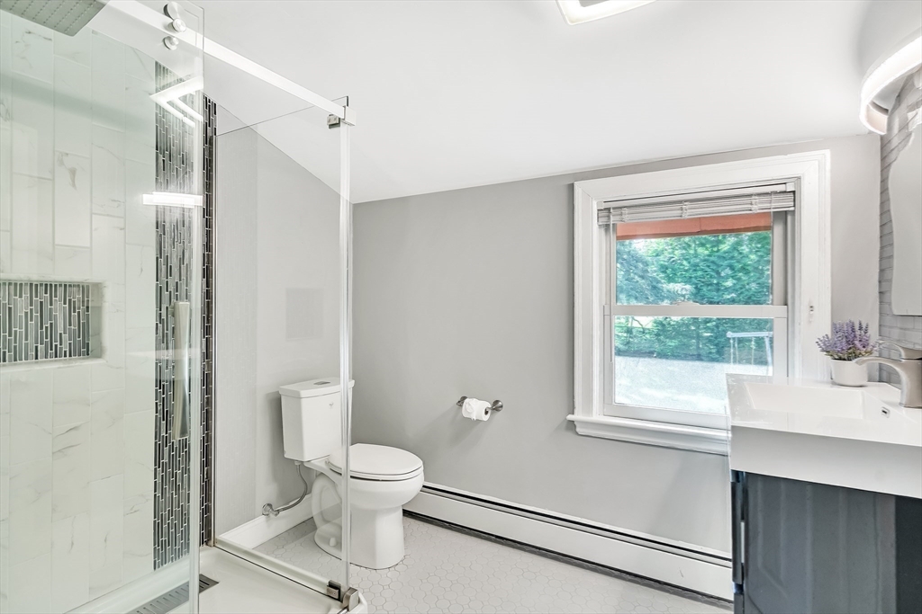 38 Maple Street Lexington, MA 02420 - Photo 27 of 40 a bathroom with a toilet a sink and a window