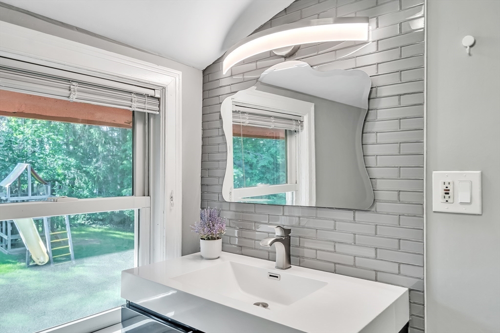 38 Maple Street Lexington, MA 02420 - Photo 28 of 40 a bathroom with a sink a mirror and next to a window