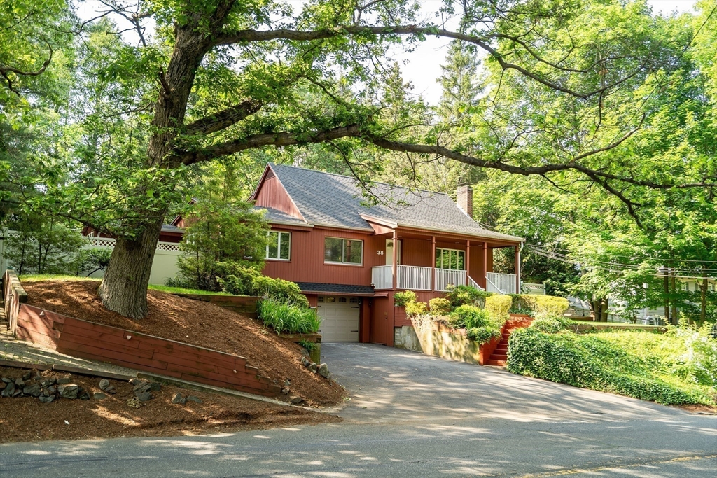 38 Maple Street Lexington, MA 02420 - Photo 29 of 40 a front view of a house with a yard and garage