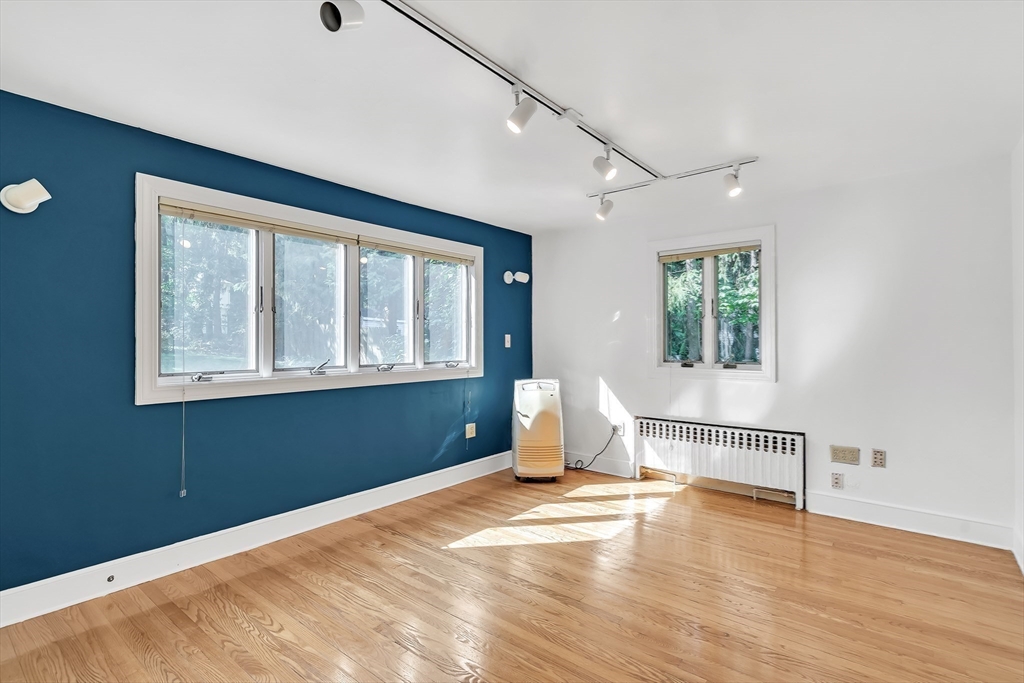 38 Maple Street Lexington, MA 02420 - Photo 9 of 40 a view of a livingroom with wooden floor and a window