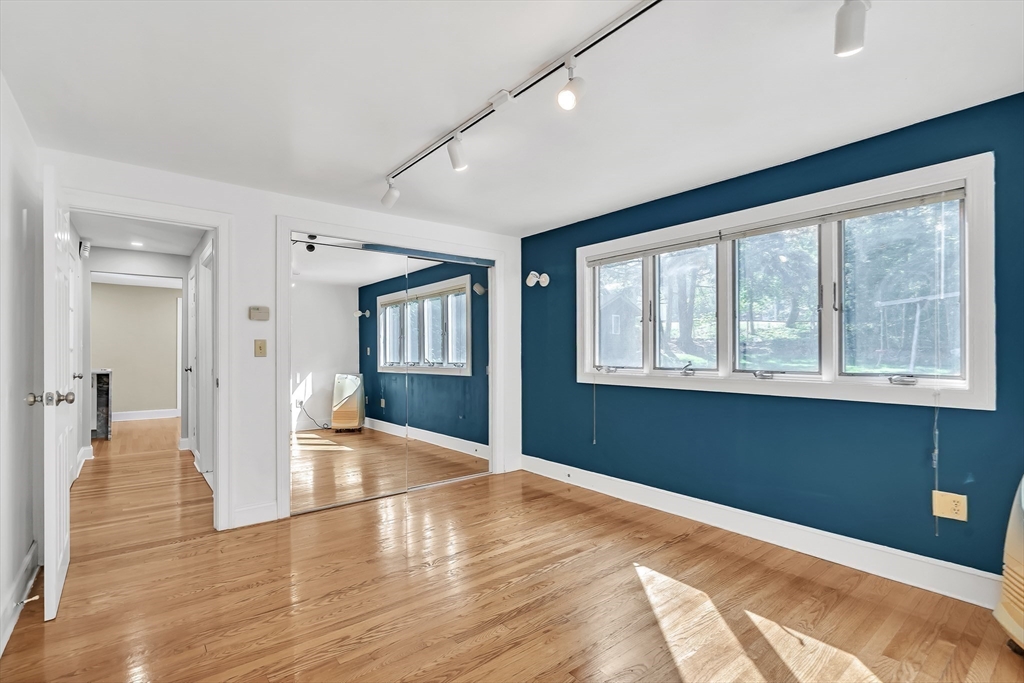 38 Maple Street Lexington, MA 02420 - Photo 10 of 40 a view of an empty room with wooden floor and a window
