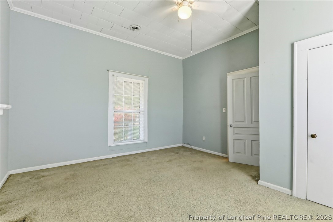 249 Nicholson Road Rockingham, NC 28379 - Photo 10 of 47 an empty room with a chandelier fan