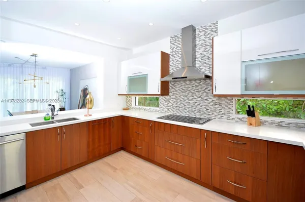 a kitchen with stainless steel appliances granite countertop a sink and a microwave