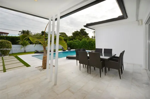 a building outdoor space with patio furniture and potted plants