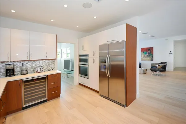 a kitchen with stainless steel appliances kitchen island granite countertop a refrigerator and a stove