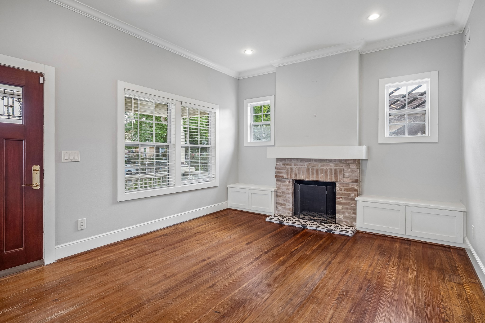 4412 Rusk Street Houston, TX 77023 - Photo 6 of 44 Closer view of brick enclosed fireplace with window seats on either side. Perfect for extra seating & great for additional storage!