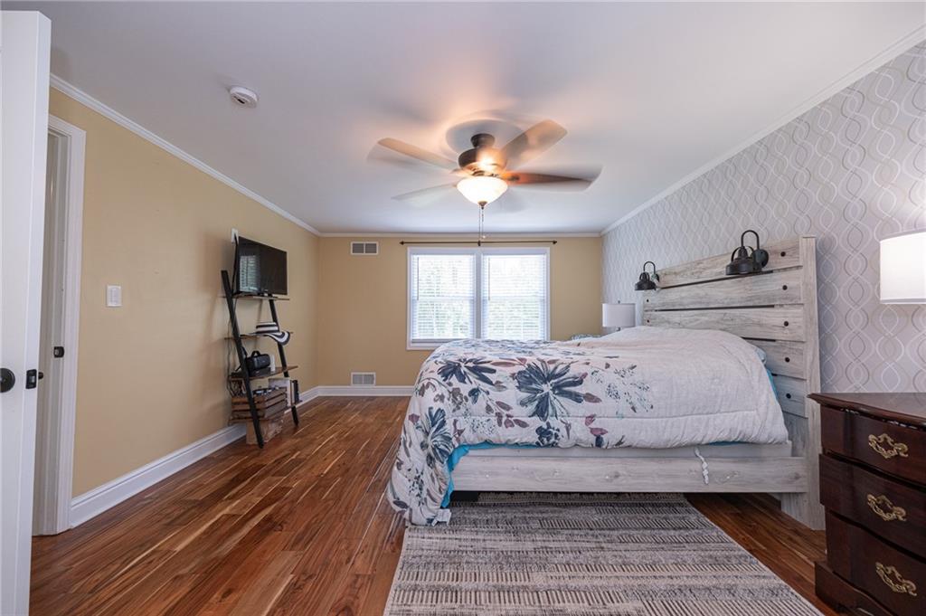 1072 Renton Road Pittsburgh, PA 15239 - Photo 14 of 42 a bedroom with a bed and a chandelier