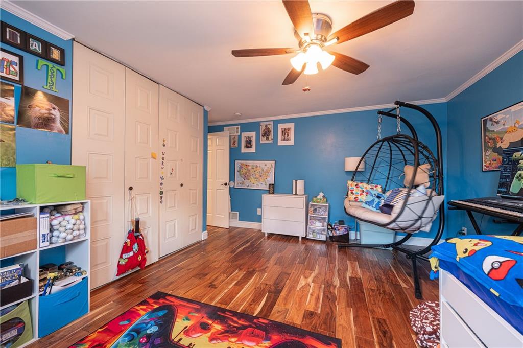 1072 Renton Road Pittsburgh, PA 15239 - Photo 20 of 42 a living room with baby crib furniture and a baby crib