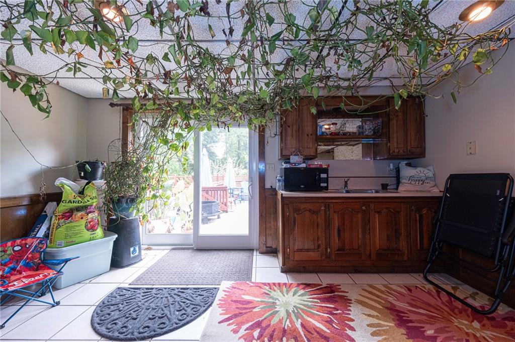 1072 Renton Road Pittsburgh, PA 15239 - Photo 27 of 42 a room with lots of flowers washer and a potted plant