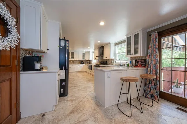 a kitchen with a table and chairs in it