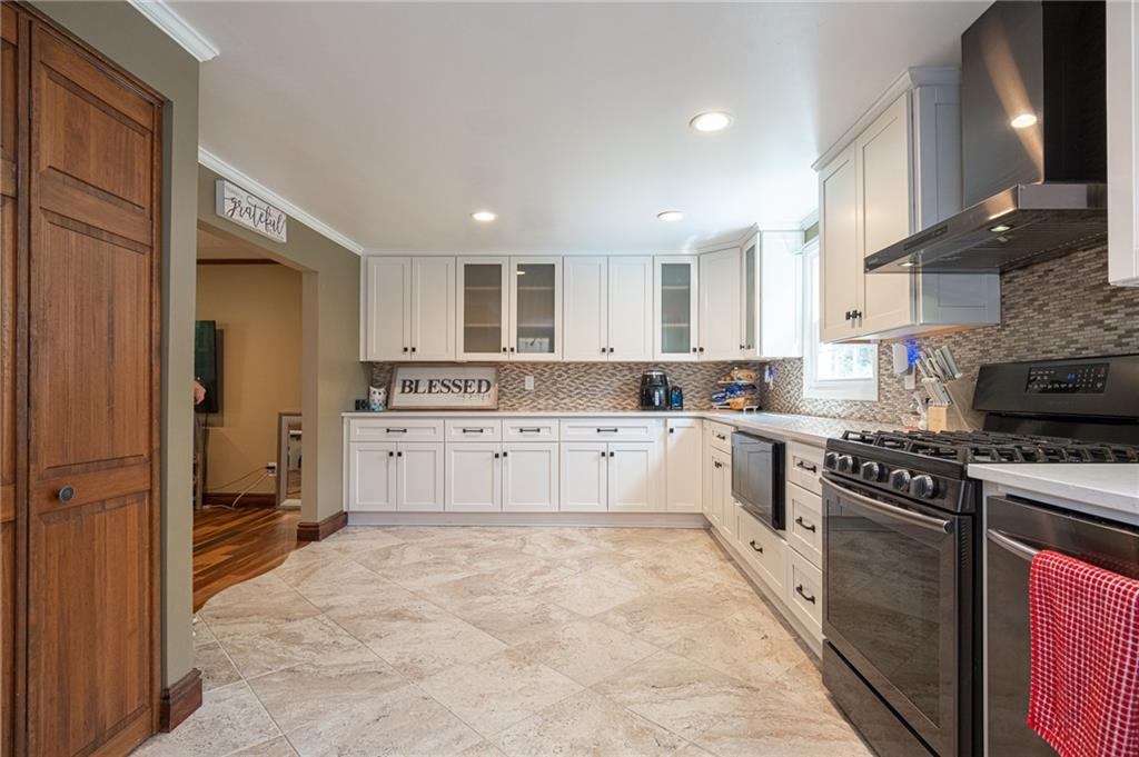 1072 Renton Road Pittsburgh, PA 15239 - Photo 6 of 42 a kitchen with stainless steel appliances granite countertop a stove top oven a sink and a refrigerator