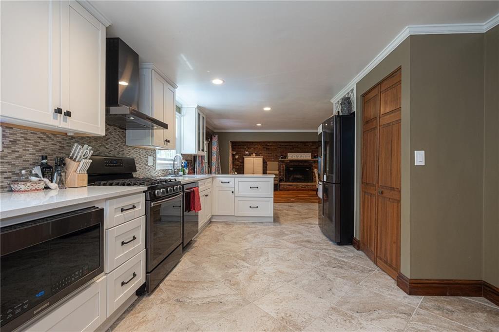 1072 Renton Road Pittsburgh, PA 15239 - Photo 8 of 42 a large kitchen with stainless steel appliances granite countertop a stove and a refrigerator