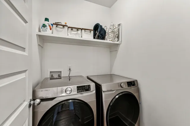 a view of staircase with white walls and a window