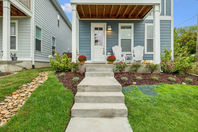 a front view of a house with garden