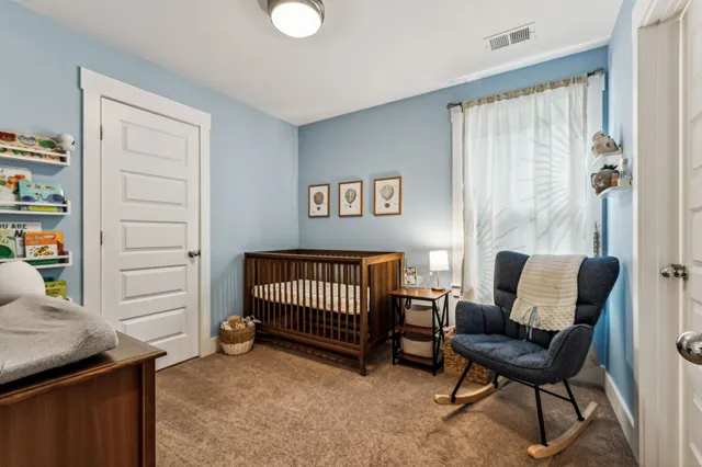 a bathroom with a granite countertop sink a toilet mirror and shower