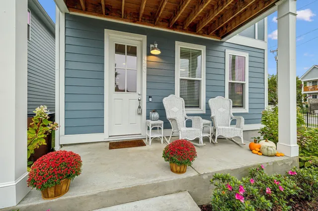 a front view of a house with outdoor seating