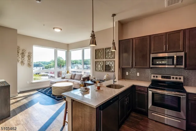 a kitchen with a stove a sink and a refrigerator
