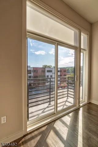 a view of a room with wooden floor and windows