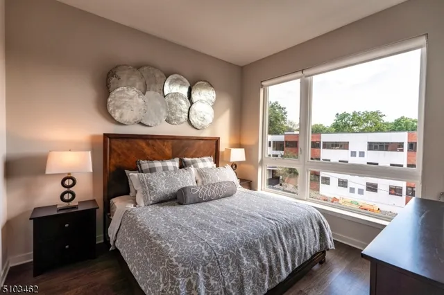 a bedroom with a large bed and a large window