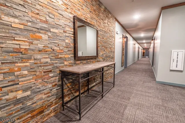 a view of a hallway with seating area