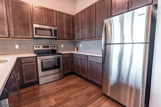 a kitchen with wooden cabinets and white appliances