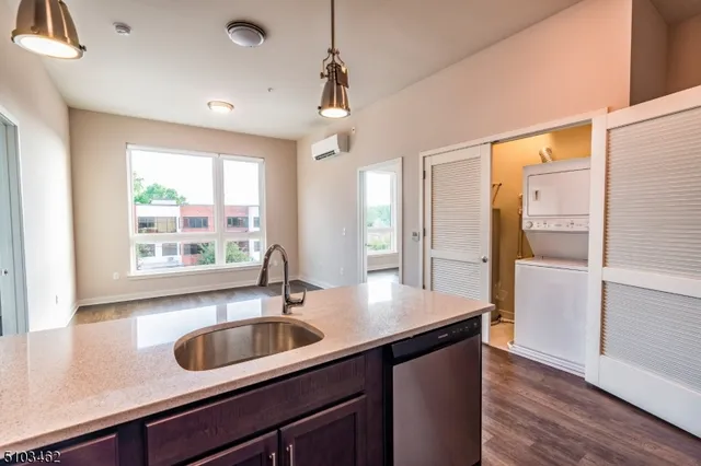 a kitchen with sink refrigerator and window