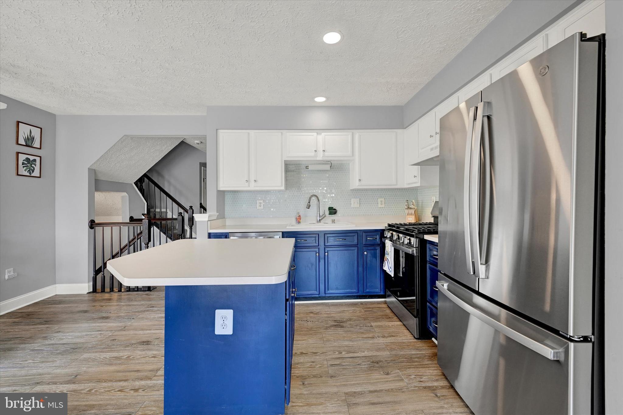 402 MacIntosh Circle Joppa, MD 21085 - Photo 11 of 29 a kitchen with kitchen island a counter top space cabinets and stainless steel appliances