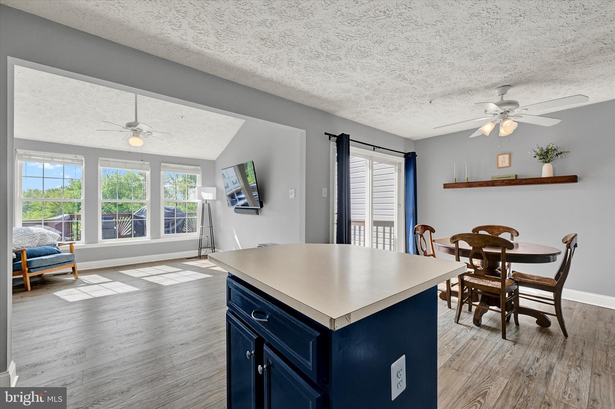 402 MacIntosh Circle Joppa, MD 21085 - Photo 12 of 29 a living room with dining table and wooden floor