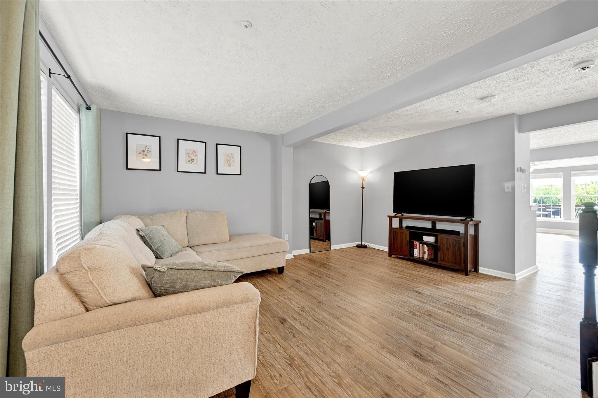 402 MacIntosh Circle Joppa, MD 21085 - Photo 4 of 29 a living room with furniture and a flat screen tv