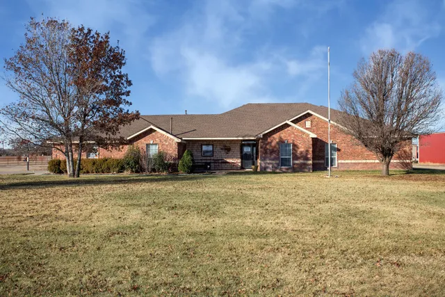 a front view of house with yard and green space