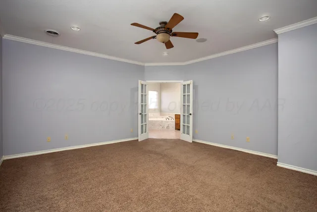 an empty room with closet and fan