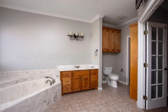 a bathroom with a tub sink and mirror