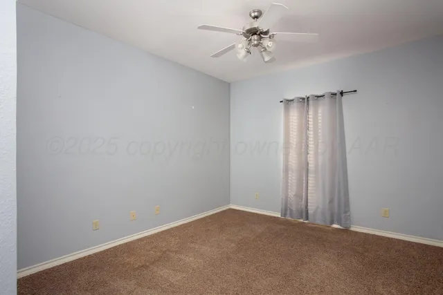 a view of an empty room with a bathroom