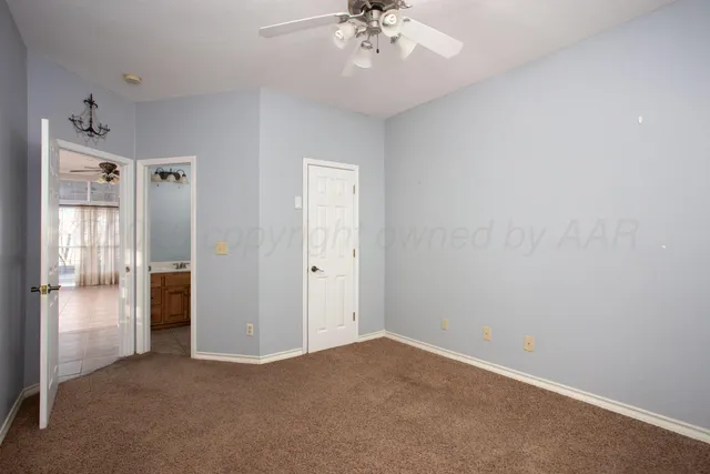 a bathroom with a toilet sink vanity and mirror