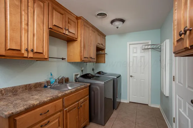 a kitchen with granite countertop cabinets sink and window