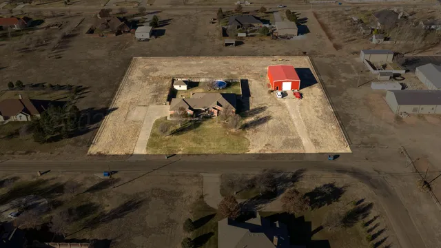 an aerial view of a house with a yard