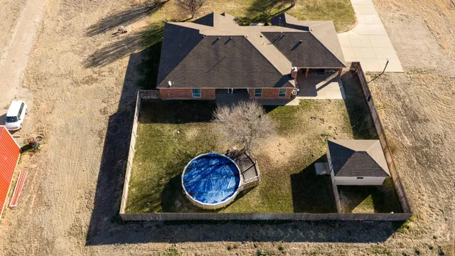 an aerial view of a house with garden space and sitting space