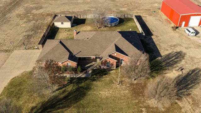 an aerial view of a house with a yard
