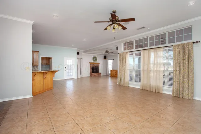 a large room with a couch and a ceiling fan