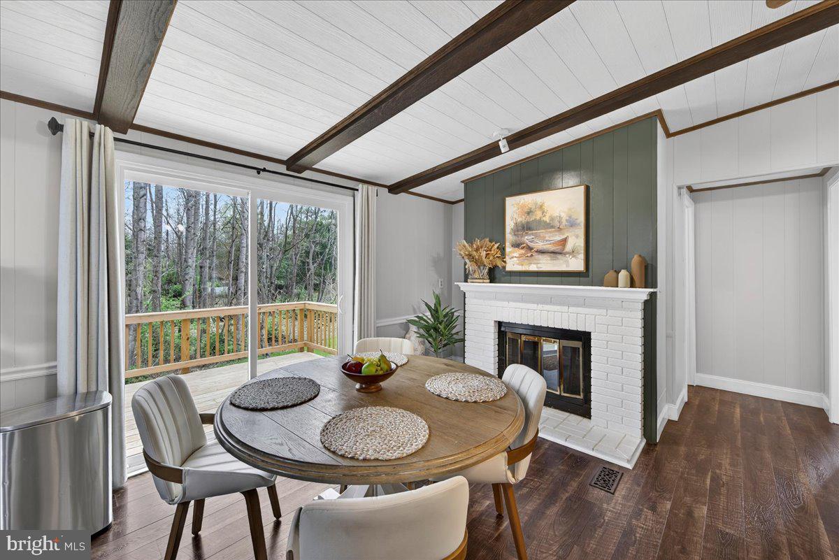 66 Ordinary Road Mineral, VA 23117 - Photo 14 of 96 a dining room with furniture a fireplace and wooden floor