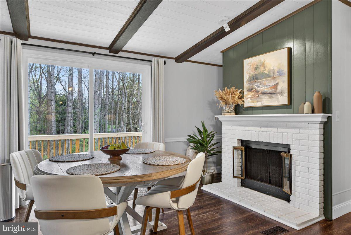 66 Ordinary Road Mineral, VA 23117 - Photo 15 of 96 a dining room with furniture a fireplace and wooden floor
