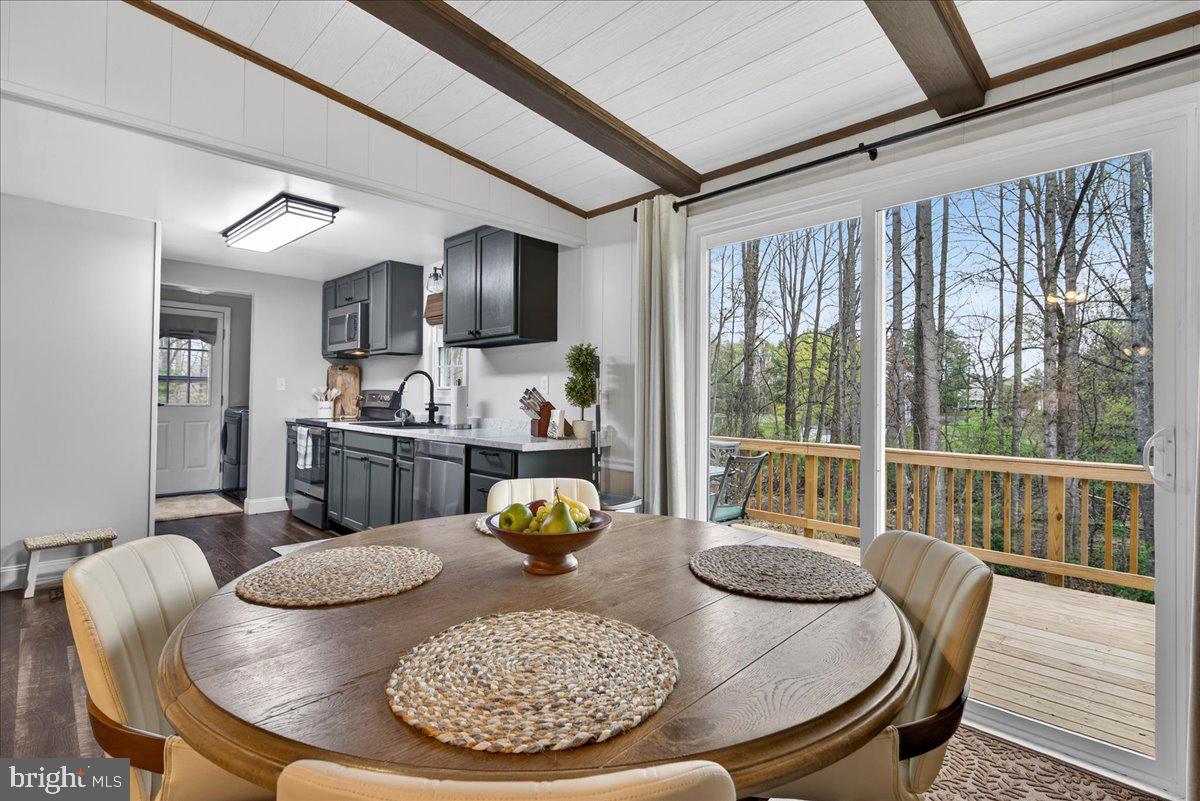66 Ordinary Road Mineral, VA 23117 - Photo 20 of 96 a view of a dining room with furniture a chandelier and wooden floor