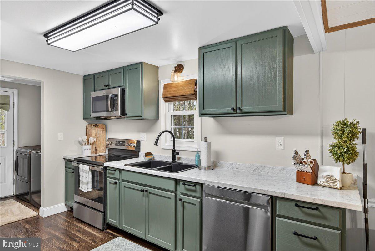 66 Ordinary Road Mineral, VA 23117 - Photo 22 of 96 a kitchen with stainless steel appliances granite countertop a sink a stove and cabinets