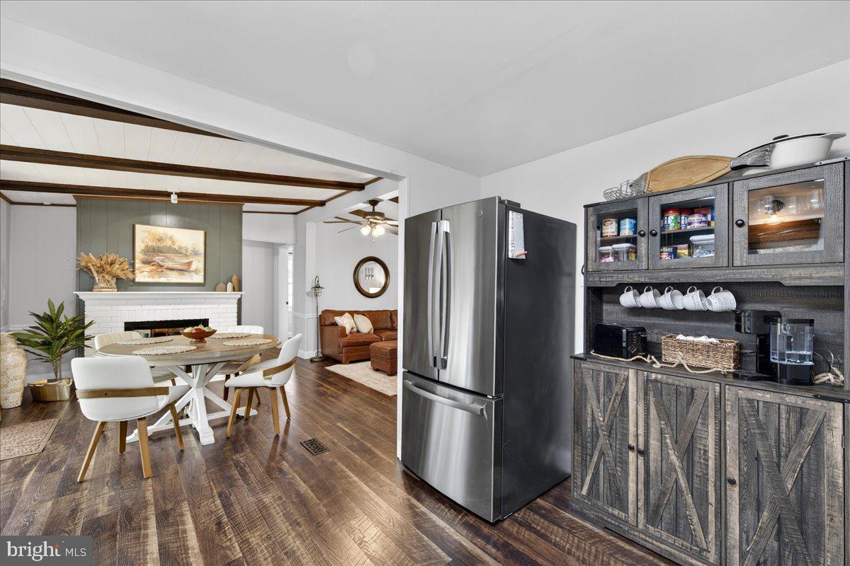 66 Ordinary Road Mineral, VA 23117 - Photo 26 of 96 a kitchen with stainless steel appliances a refrigerator a stove a dining table and chairs with wooden floor