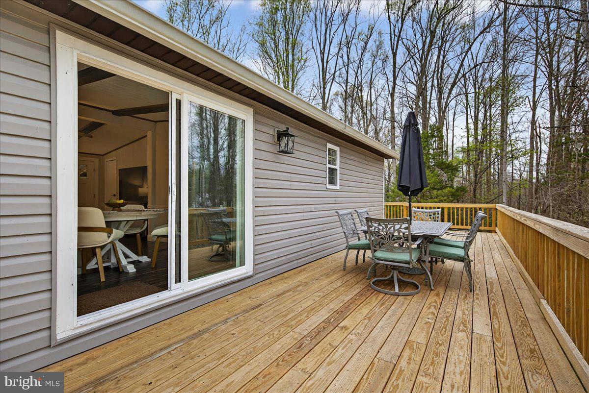 66 Ordinary Road Mineral, VA 23117 - Photo 43 of 96 a balcony with wooden floor table and chairs
