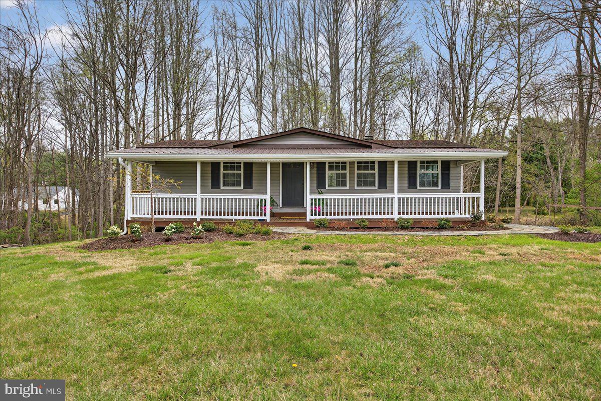 66 Ordinary Road Mineral, VA 23117 - Photo 57 of 96 a front view of a house with a garden and trees