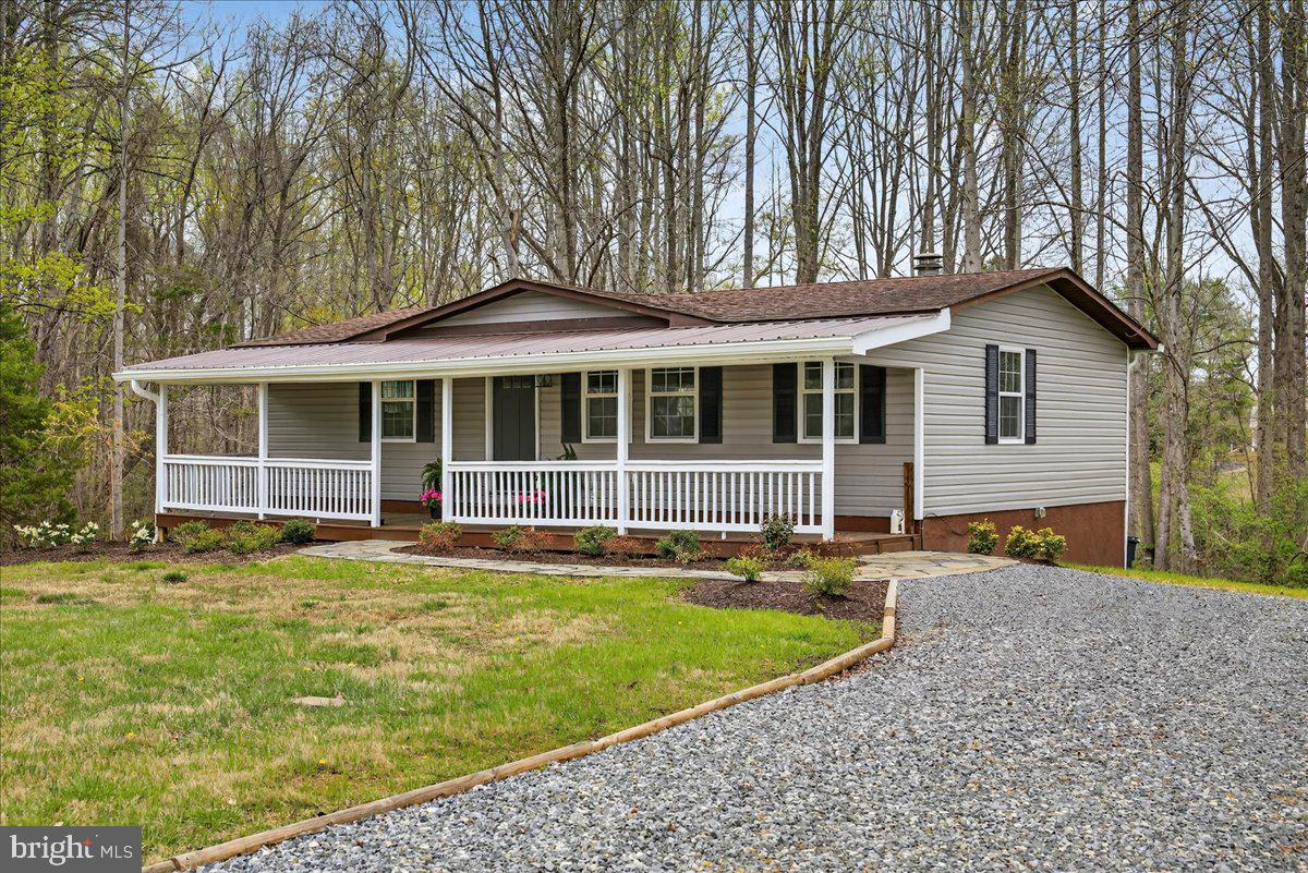 66 Ordinary Road Mineral, VA 23117 - Photo 66 of 96 a front view of a house with a yard table and chairs