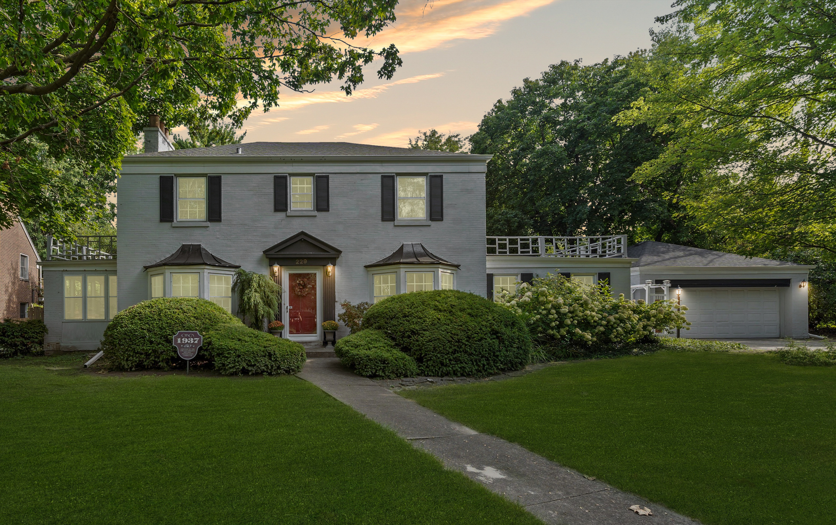 a front view of a house with a garden