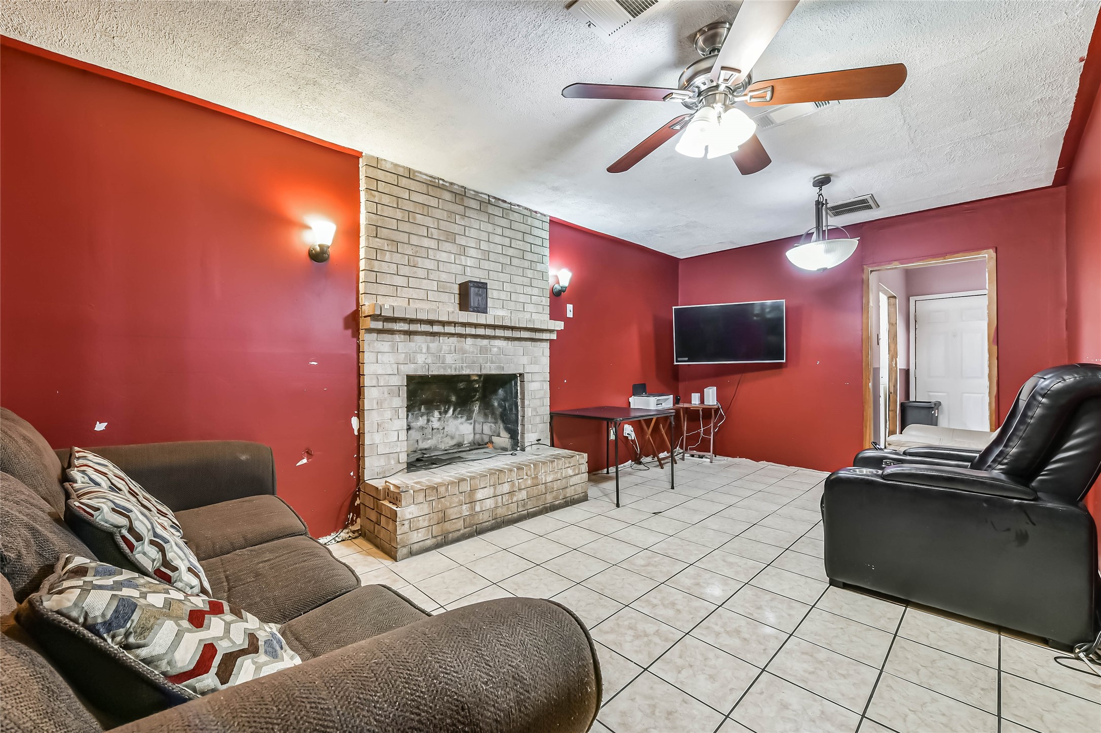 10438 Caxton Street Houston, TX 77016 - Photo 8 of 24 a living room with furniture and a fireplace