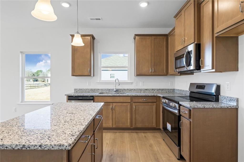 22 Willow Circle Rock Spring, GA 30739 - Photo 11 of 41 a kitchen with stainless steel appliances granite countertop a sink stove and microwave
